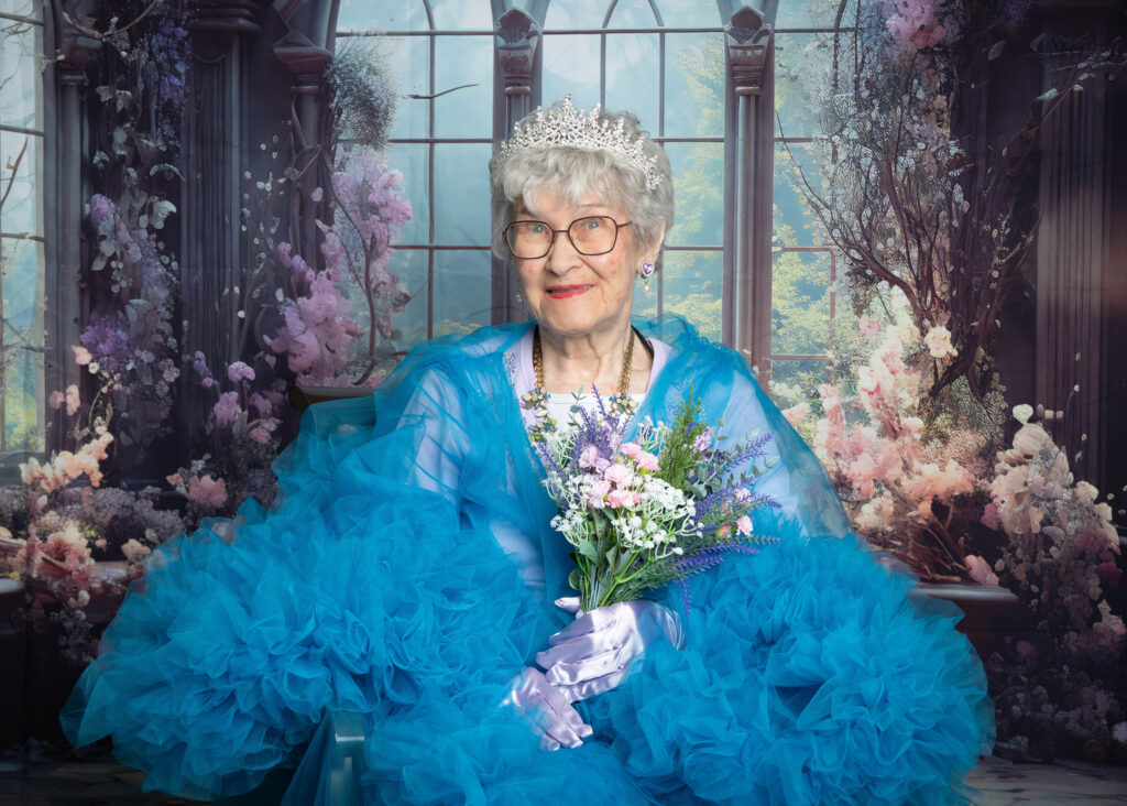Resident smiling after her Glam Day makeover at Smithfield Lodge in Westlock while getting her photo taken