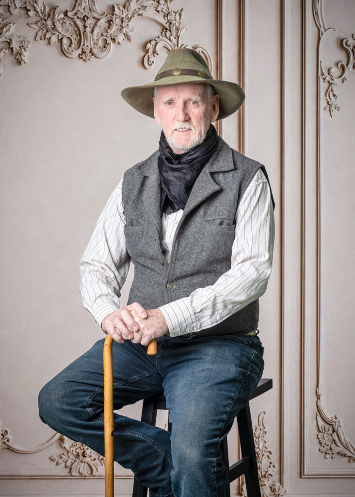 Resident smiling after his Glam Day photo session at Smithfield Lodge in Westlock while getting his photo taken