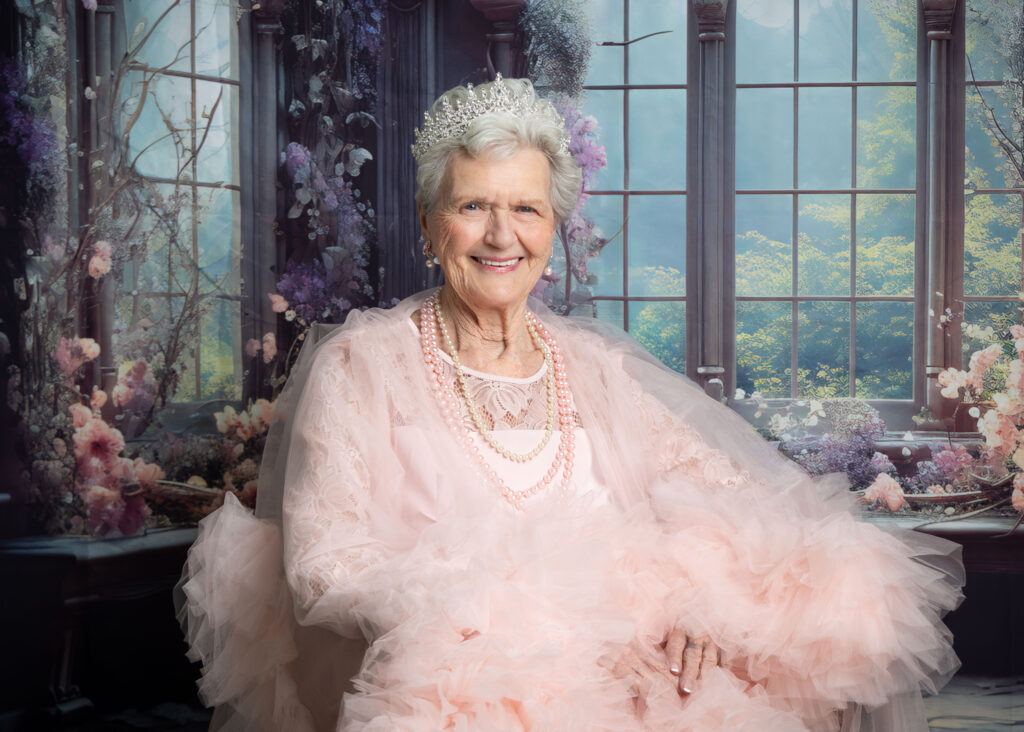 Resident smiling after her Glam Day makeover at Smithfield Lodge in Westlock while getting her photo taken