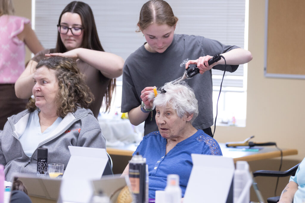 Seniors getting hair and makeup done for Glam Day by RF Staples students at Smithfield Lodge in Westlock.