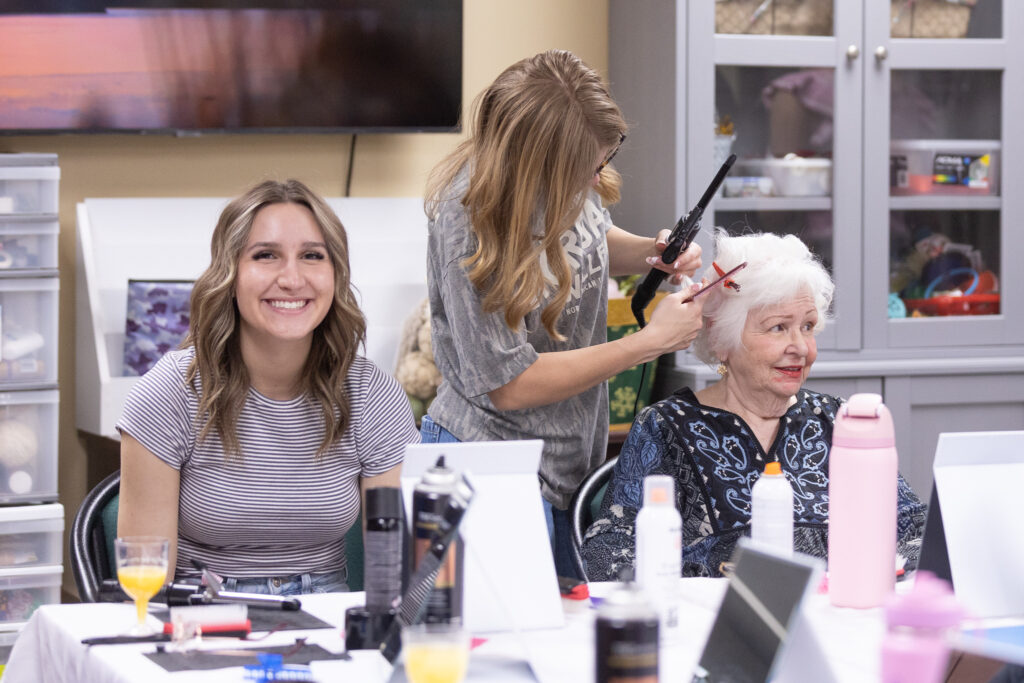 Seniors at Smithfield Lodge getting their hair and makeup done by RF Students for Glam Day.